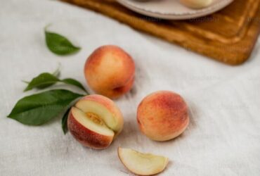 Fresh peaches on wooden board and cloth.